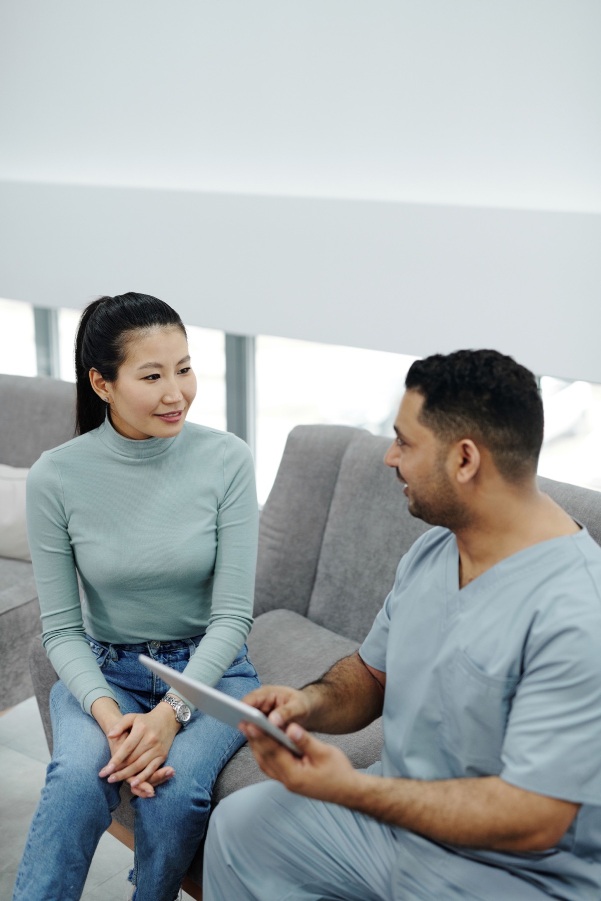 A clinician listens while speaking privately with a patient in a calm care setting
